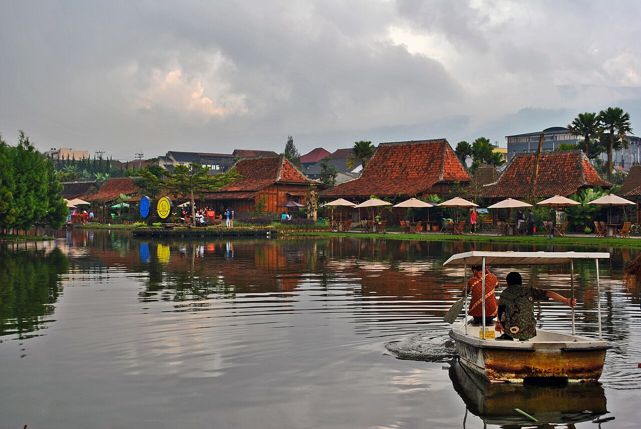 Scenic lake and traditional wooden pavilions at Floating Market Lembang, West Java