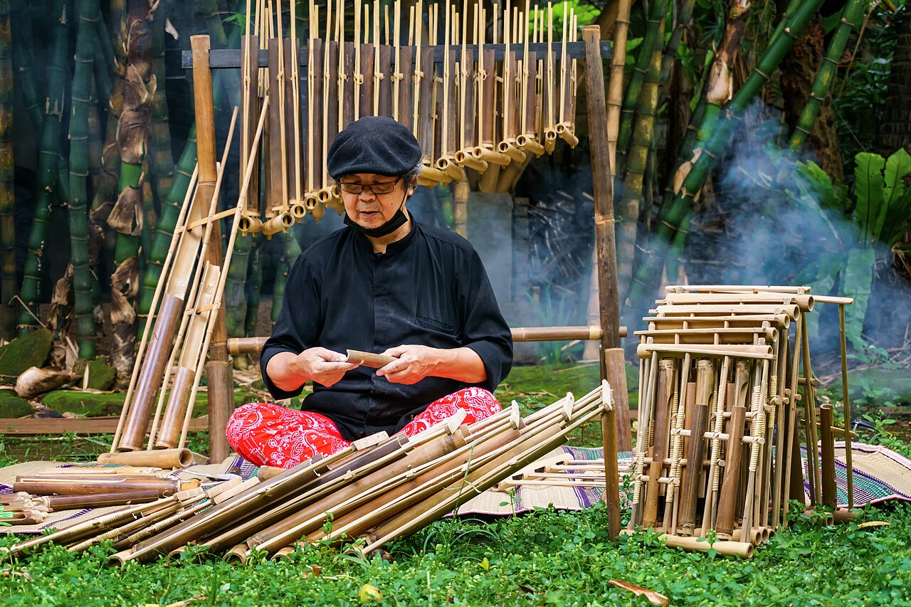 Artisan handcrafting and tuning bamboo angklung at Saung Udjo