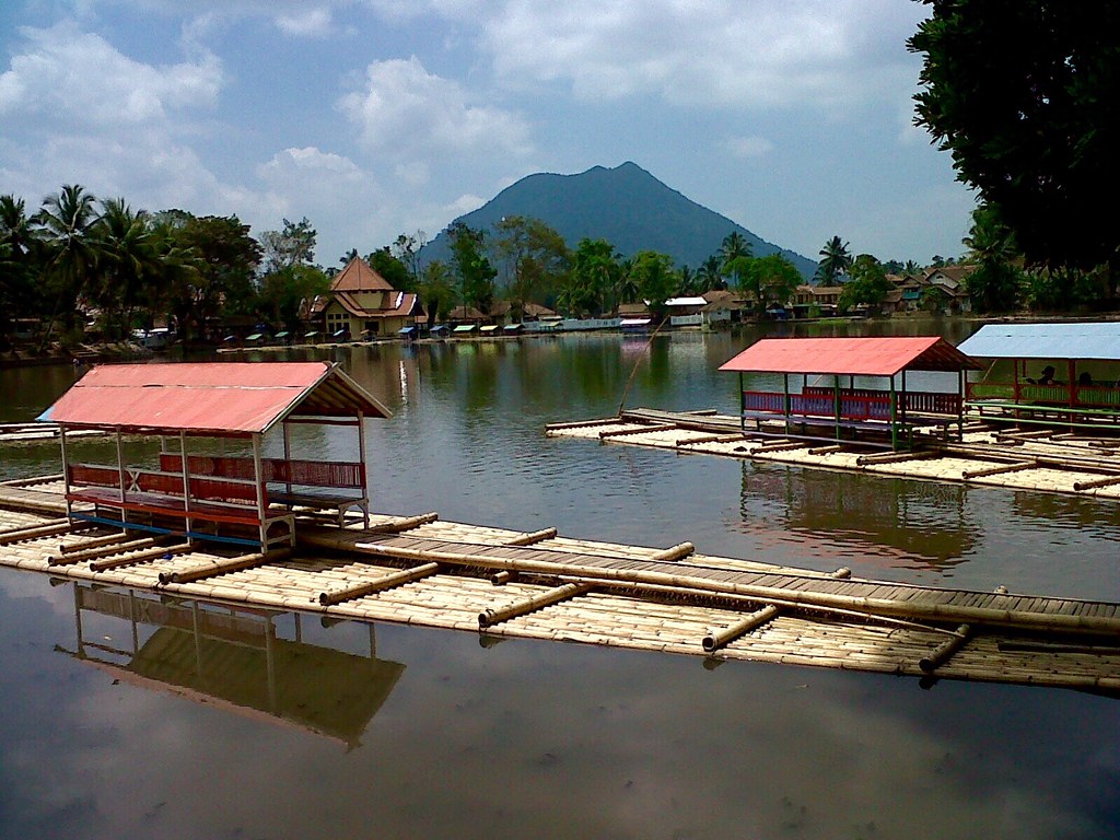 Traditional bamboo raft crossing Situ Cangkuang lake to the temple island