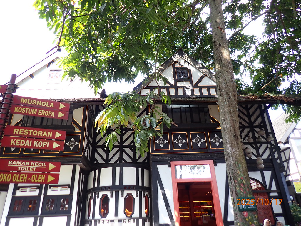 Charming European Tudor-style half-timbered manor houses with colorful flower planter boxes and costume boutique at Farm House Susu Lembang