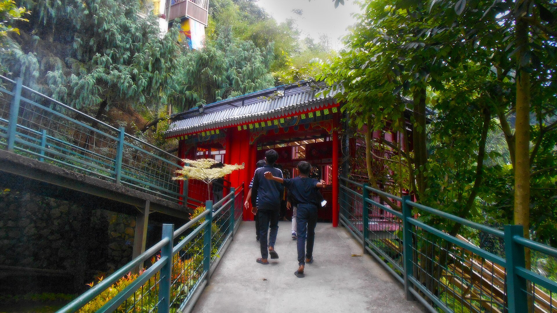 Traditional Japanese entrance pavilion and pagoda at The Great Asia Africa Lembang with the mountain funicular track beside it